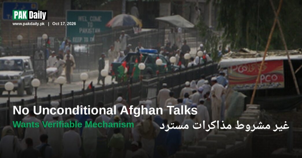 Crowds cross the Pakistan-Afghanistan border at Torkham, beneath signage reading Welcome to Pakistan