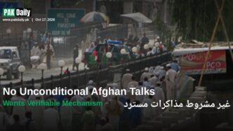 Crowds cross the Pakistan-Afghanistan border at Torkham, beneath signage reading Welcome to Pakistan